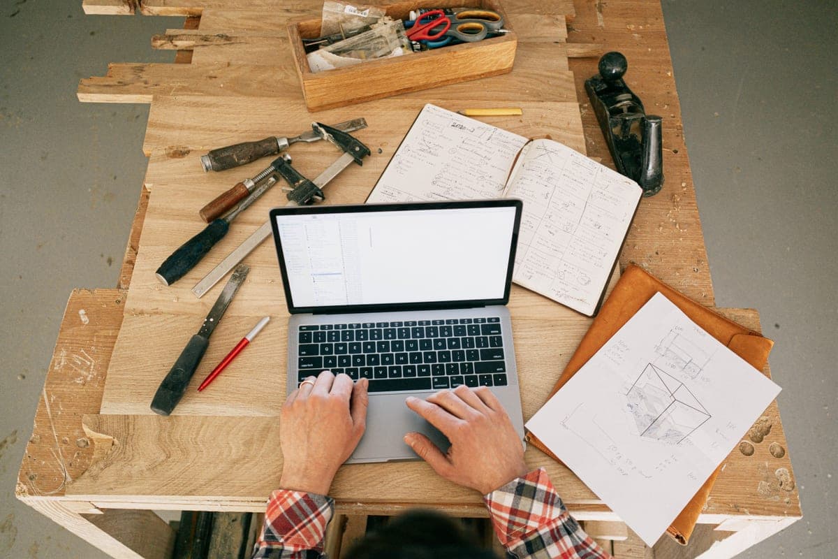 A workshop desk with manuals and notes