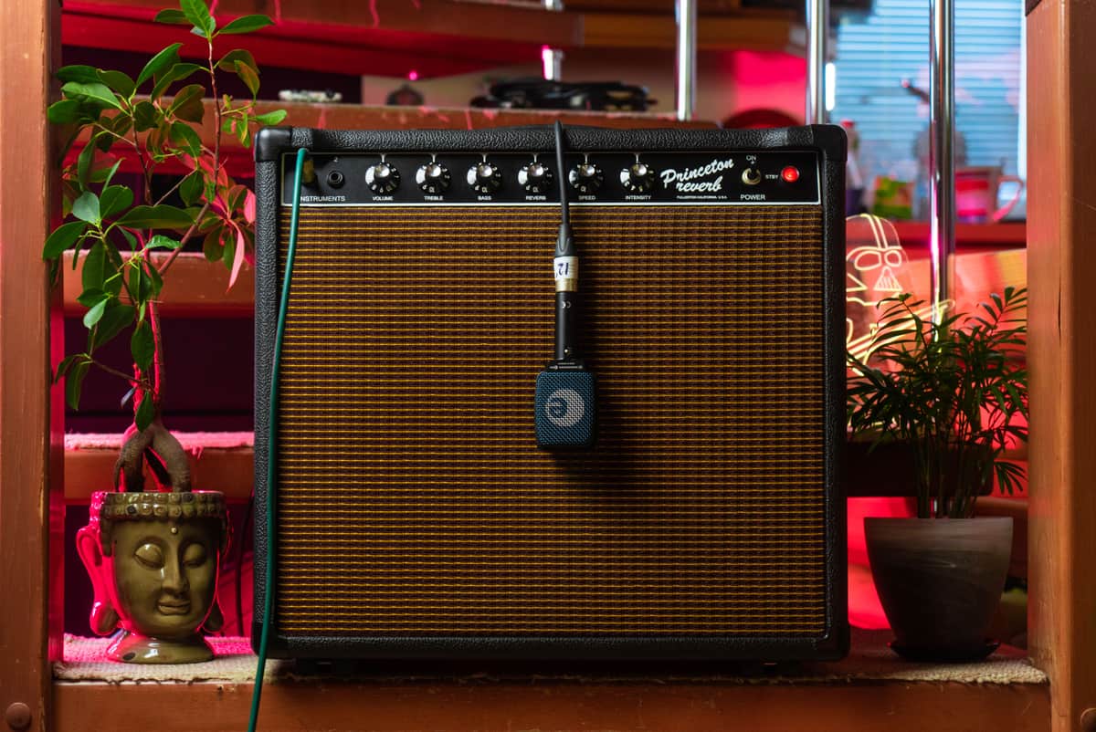 A guitar combo amplifier photographed on a wooden floor