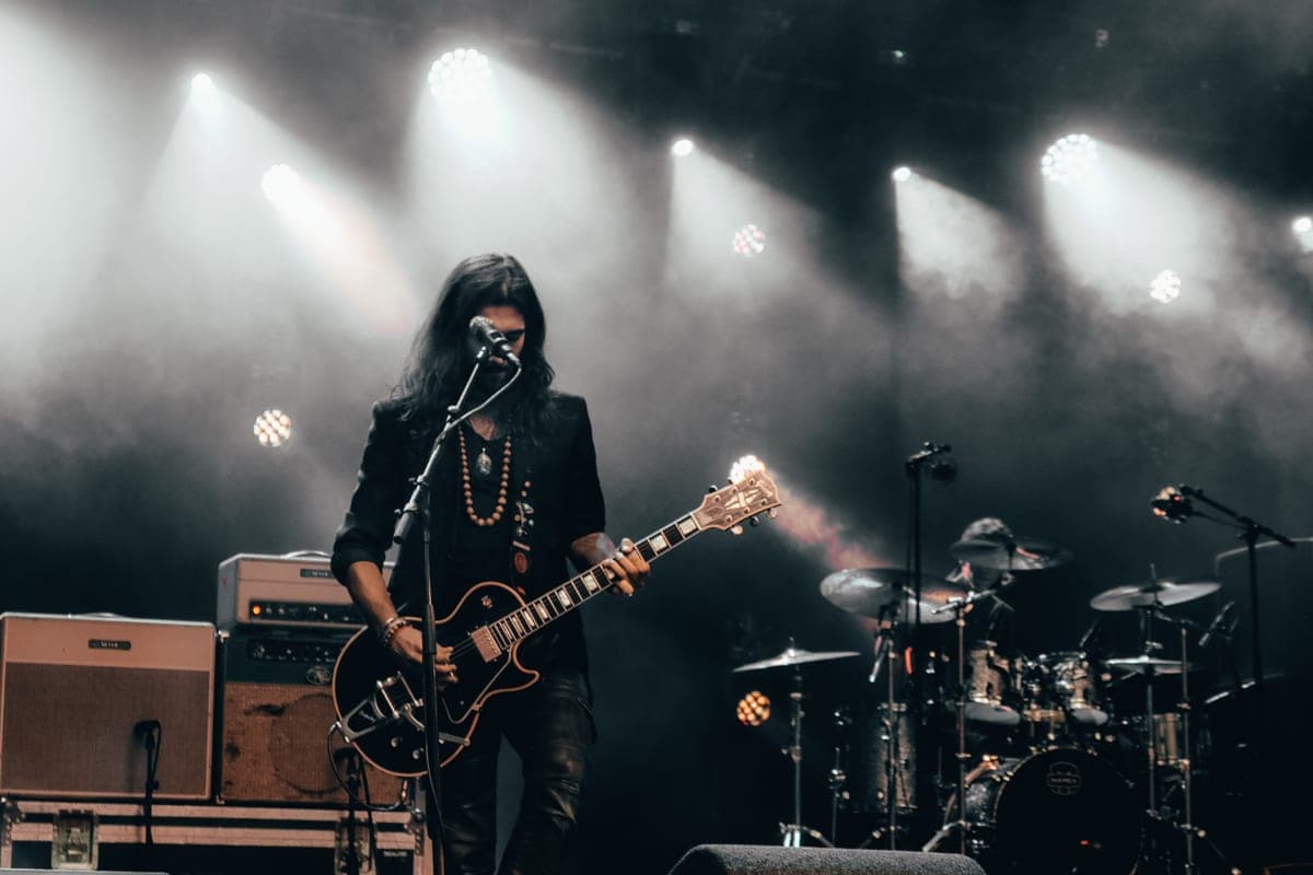 A wall of amplifier cabinets in dark stage haze