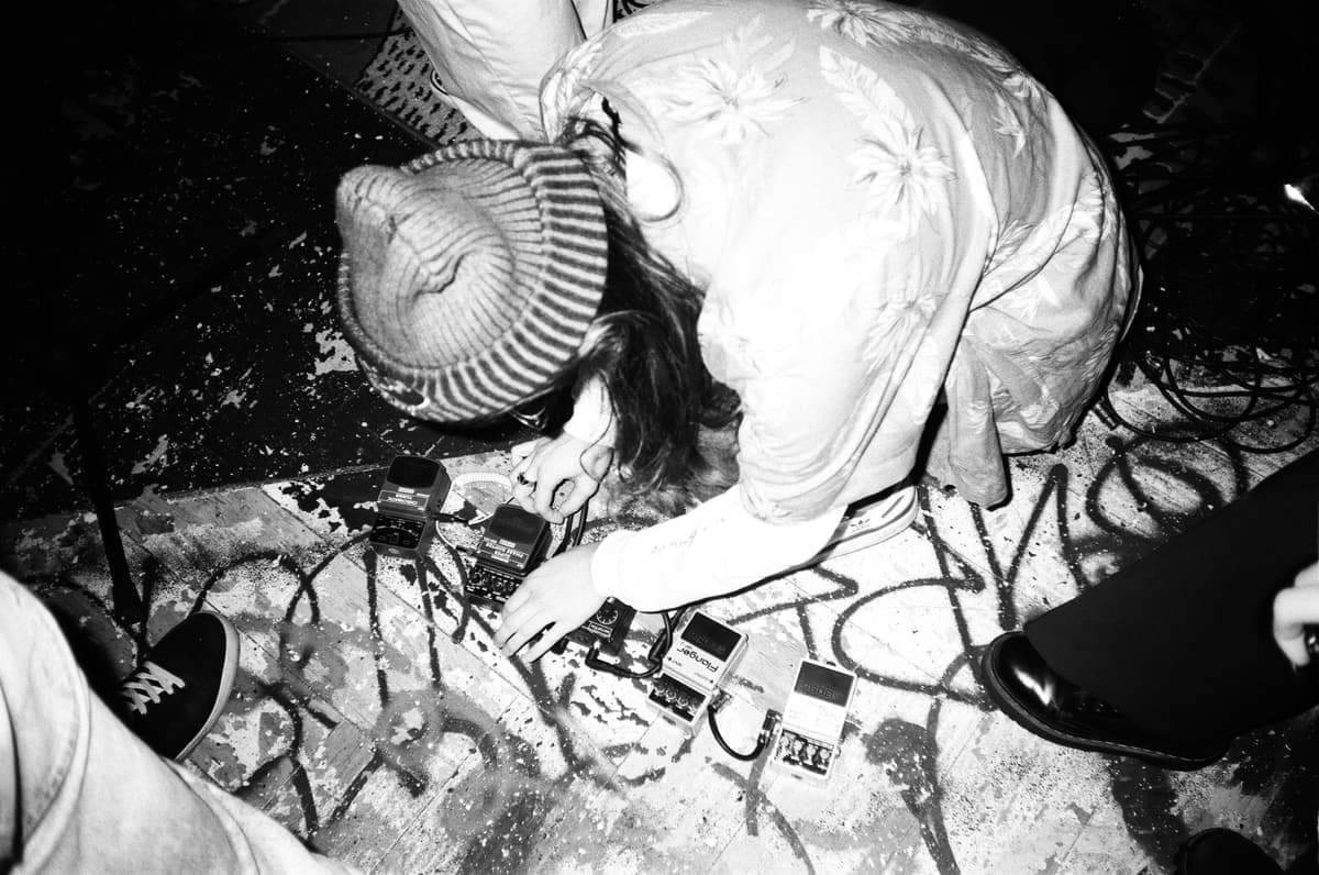 Two distortion pedals photographed on a dark surface