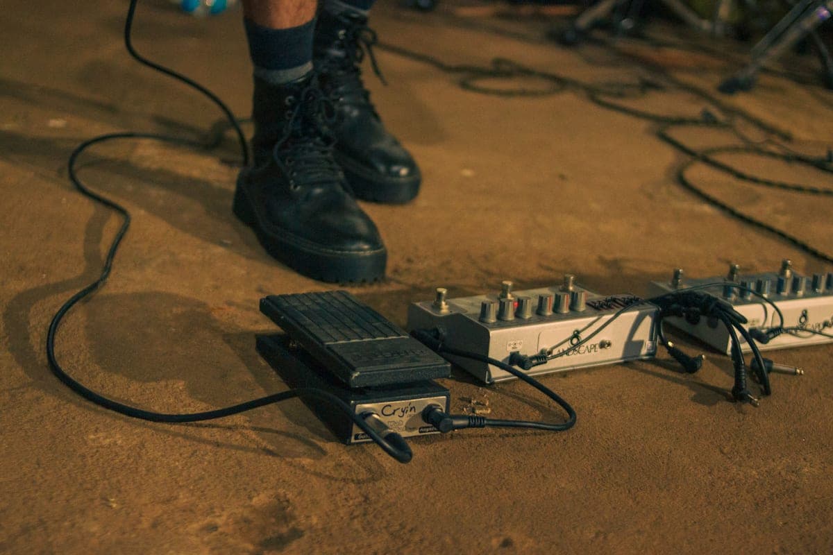 A round fuzz pedal beside a rectangular fuzz pedal