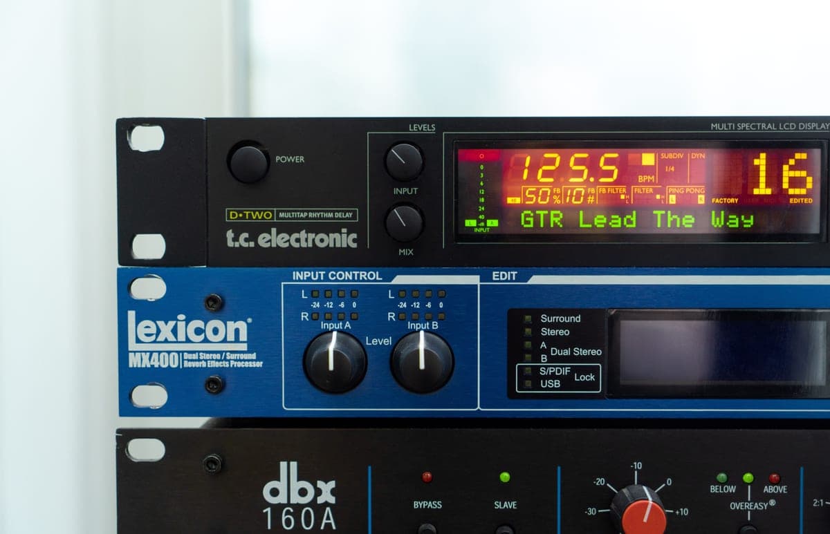 An analog delay pedal beside a digital delay pedal