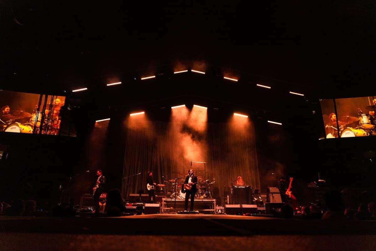 Stereo guitar effects pedals on a dark stage floor
