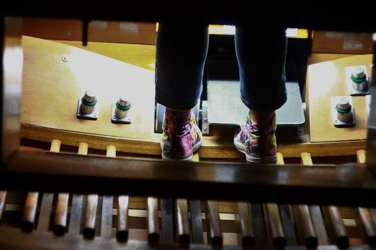 A guitarist's foot resting on a delay pedal switch