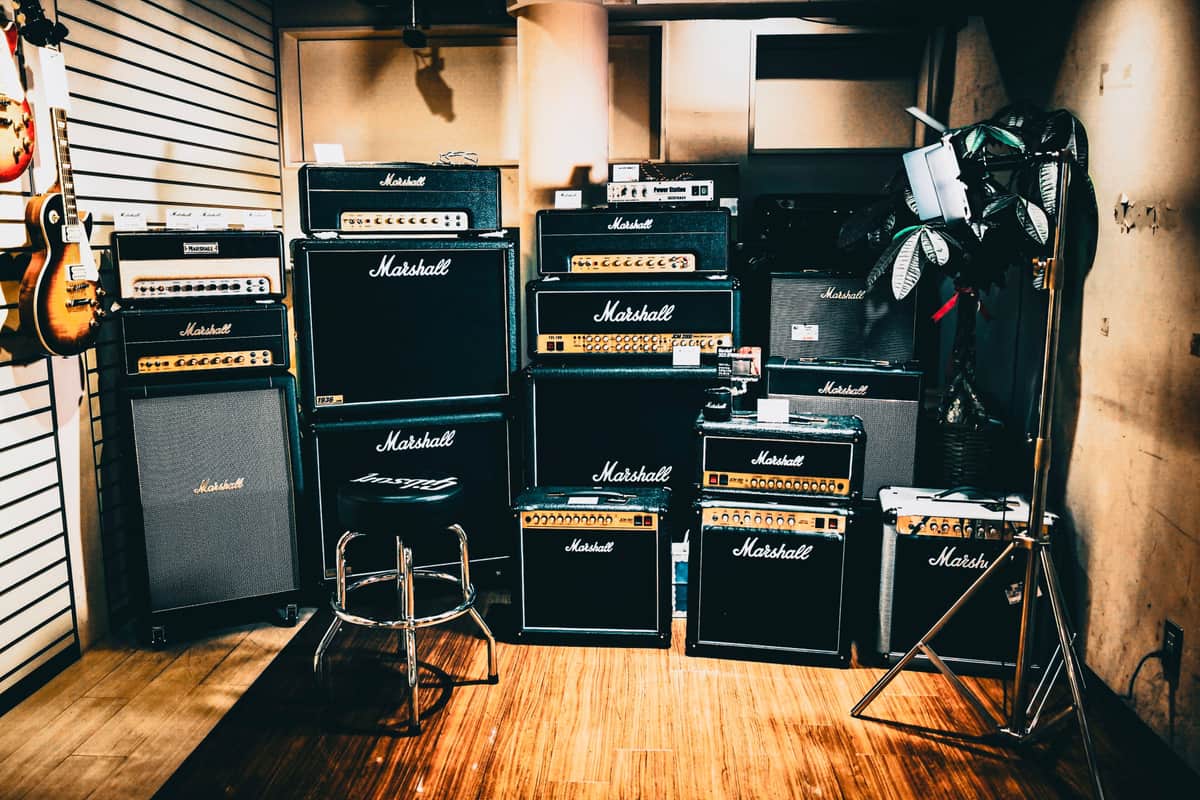 An open amplifier manual beside a guitar pedal