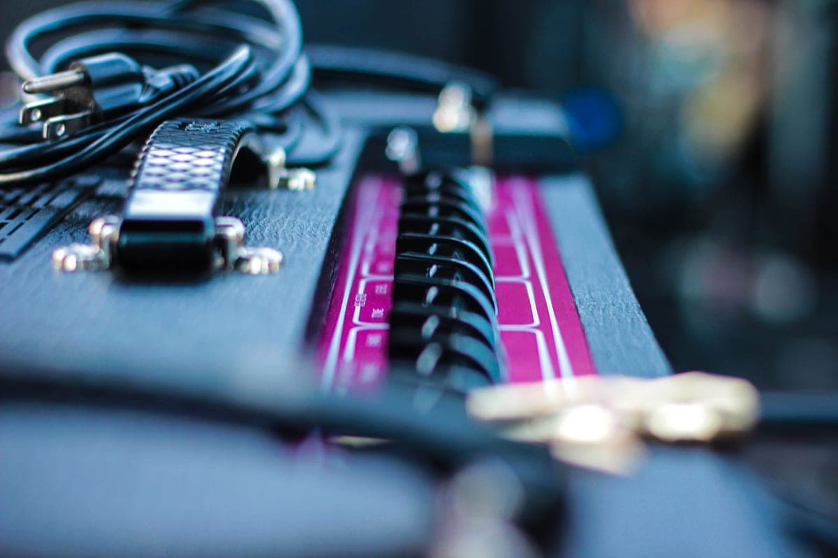 Guitar cables and a pedal input jack in close-up