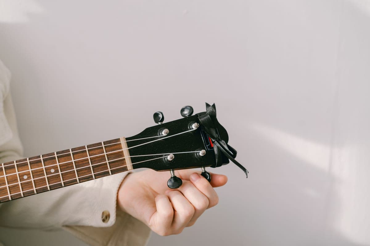 A clip-on tuner attached to a guitar headstock