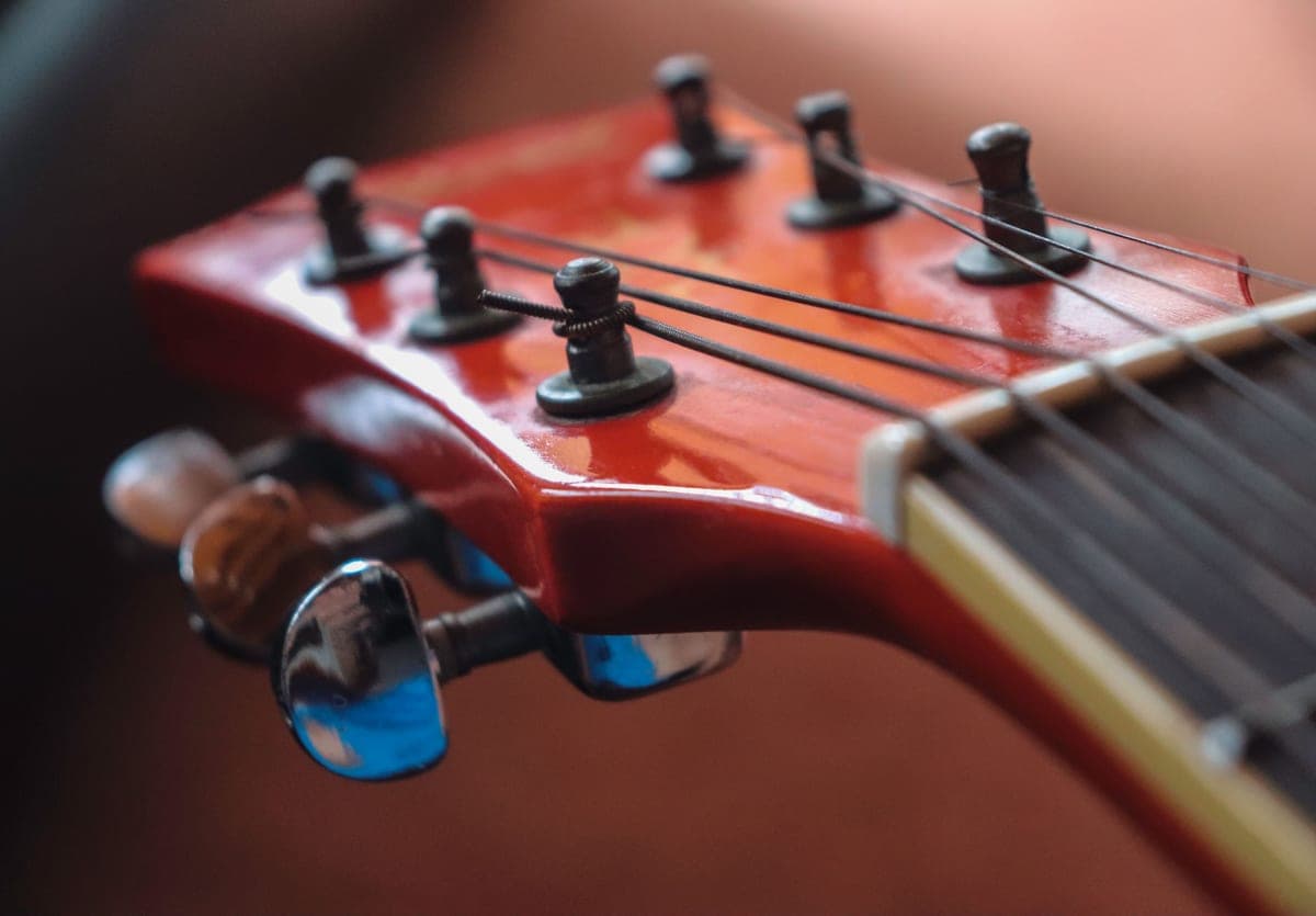 Close detail of an electric guitar headstock and tuning pegs