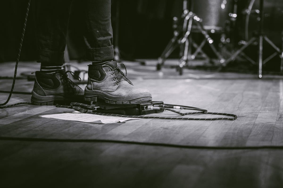 A rocker-treadle expression pedal on a dark stage floor